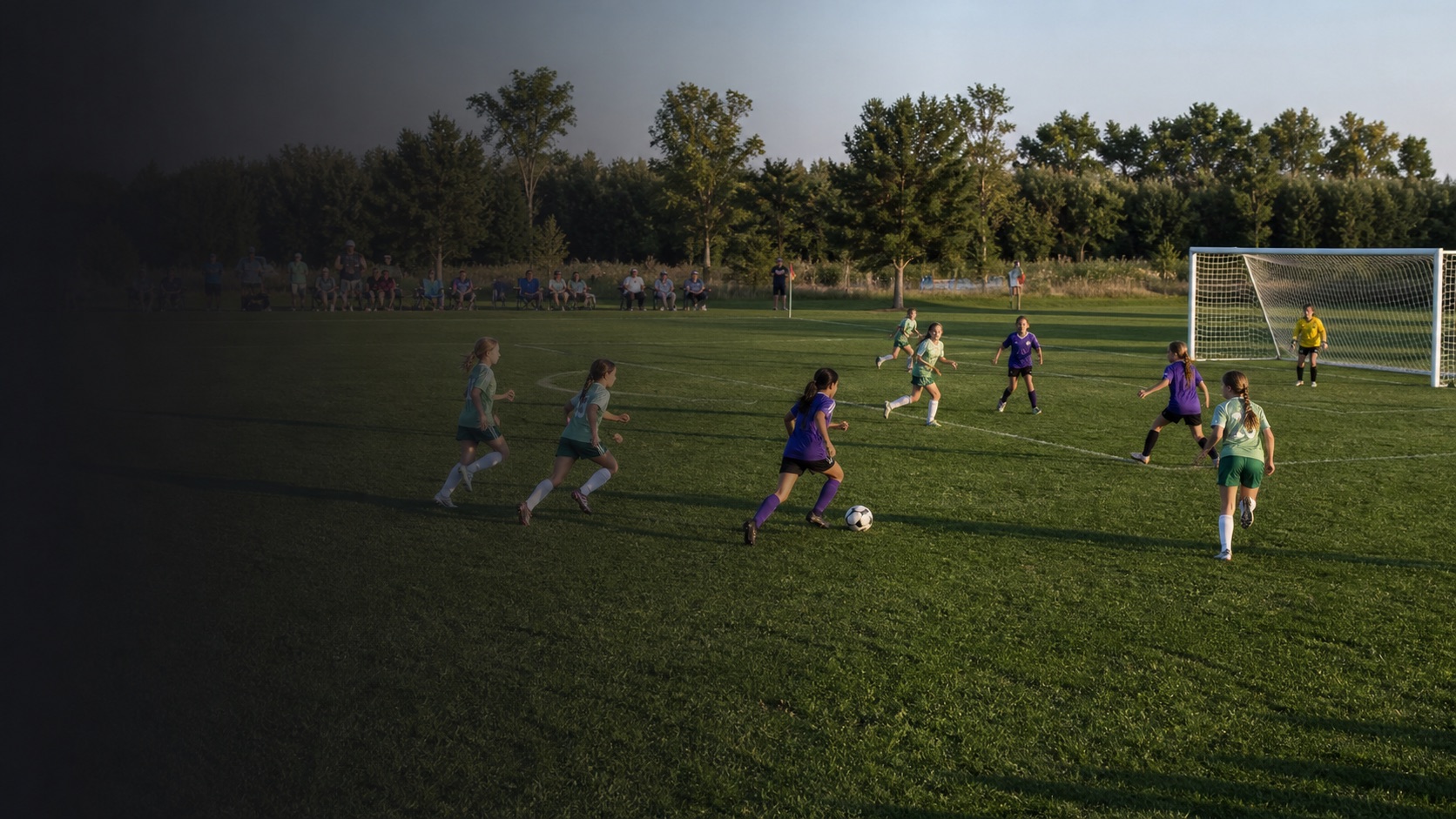 Anonymous soccer teams in purple and green playing a match